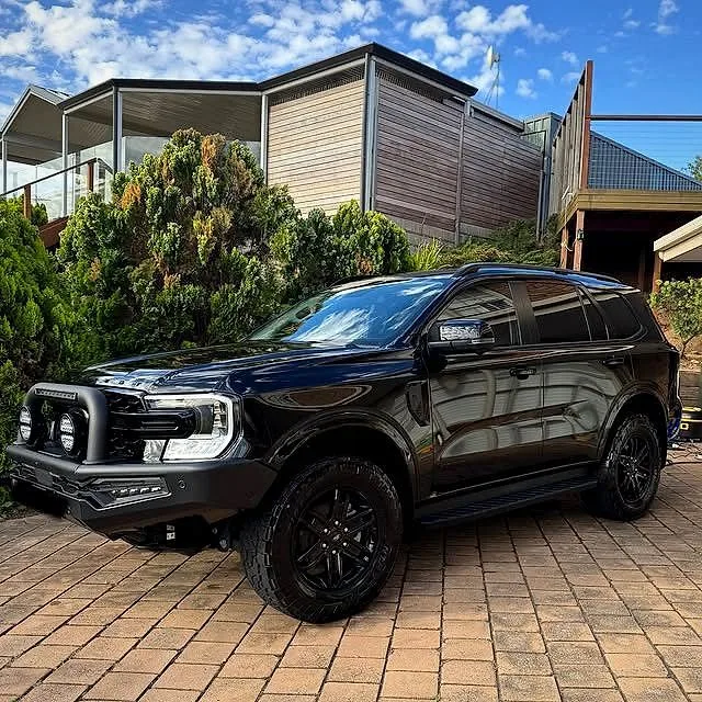 Black Ford SUV freshly detailed on a paved driveway