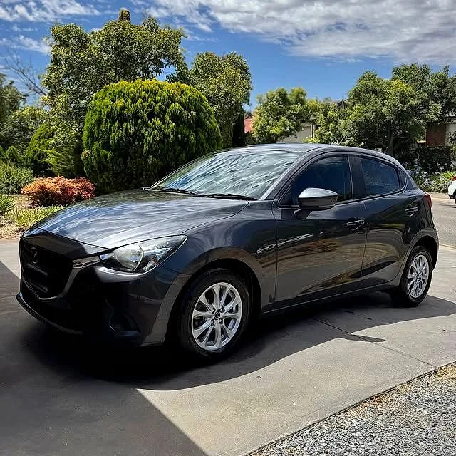 Freshly washed grey Mazda2 in an Adelaide driveway