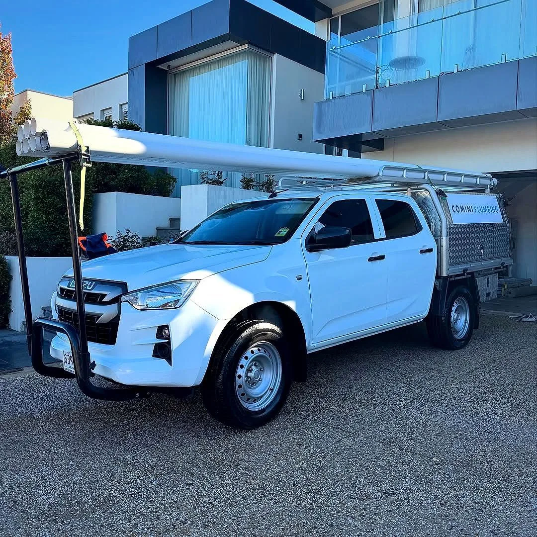 White work ute with canopy detailed at a job site